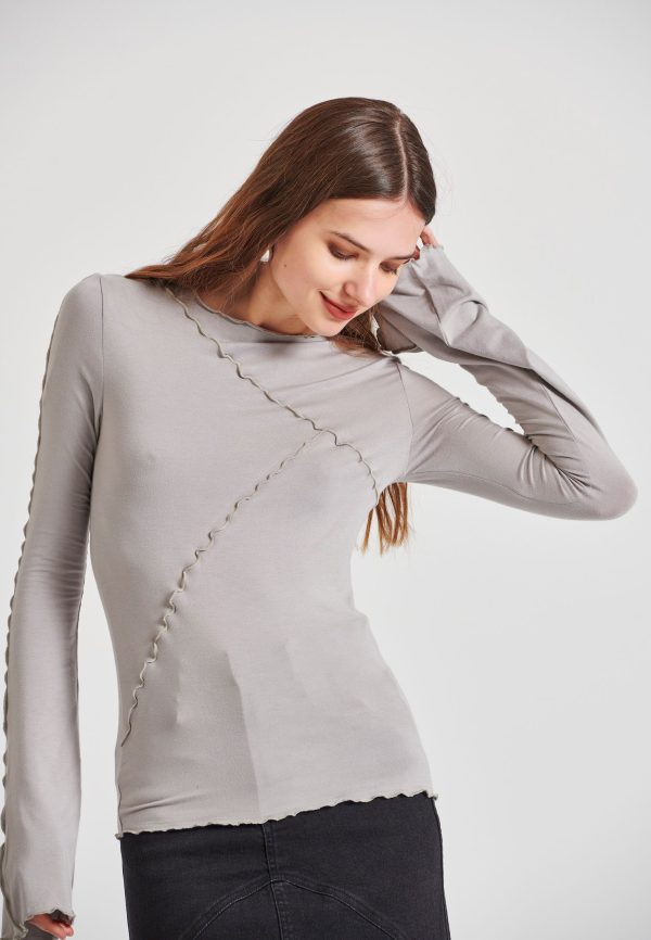 Top with decorative stitching and bell sleeves